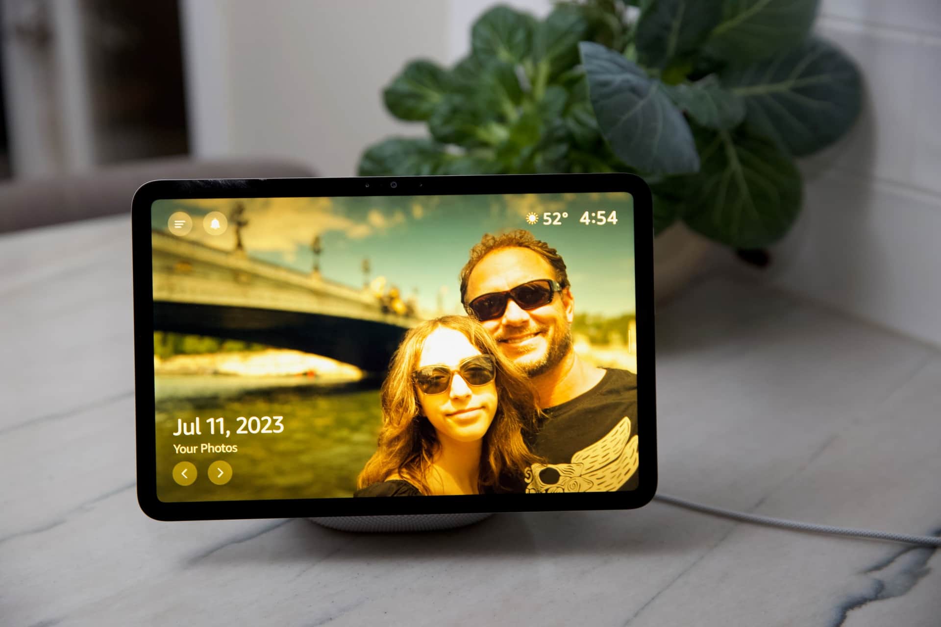 Echo screen showing two people in front of a bridge.