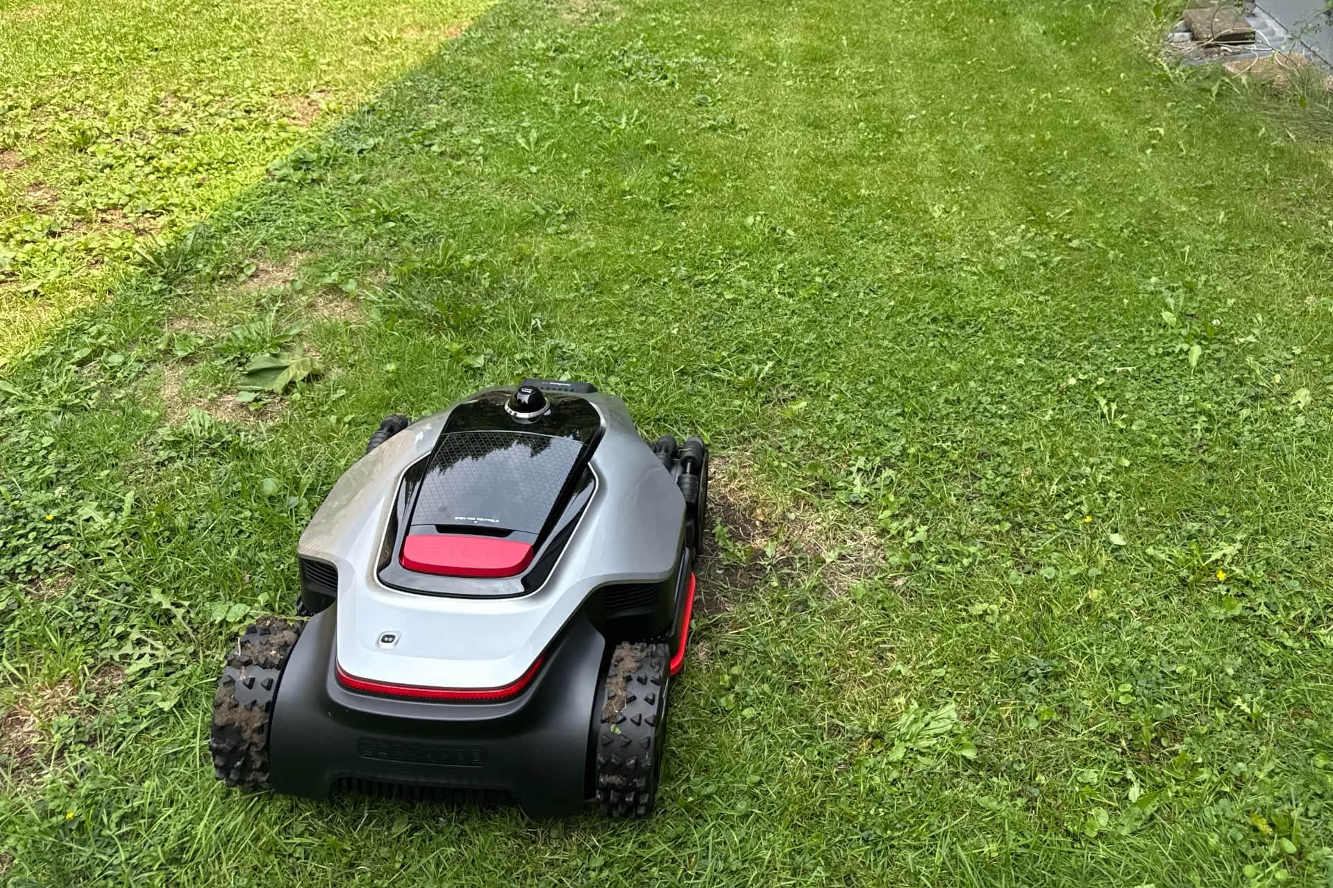 Dreame A3 AWD Pro 3500 mowing, with visible wheel tracks in the grass — © Wes Davis / Gizmodo