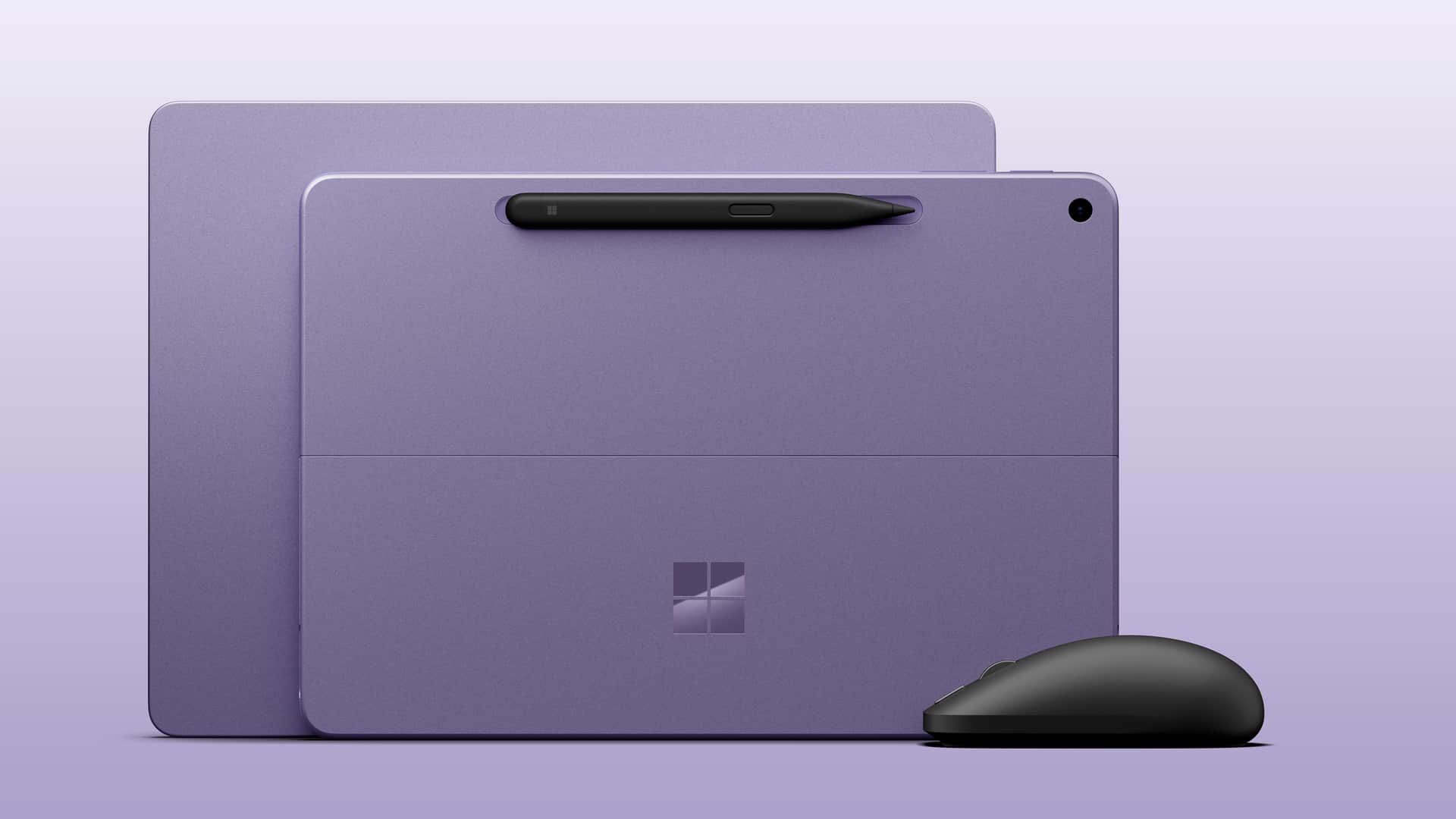 Microsoft Surface Laptop 13-inch next to Surface Laptop 12-inch, both in violet colorway next to the new black Surface Mouse. — Both Surface Laptop 13-inch and Surface Pro 12-inch 2nd Editions come in the Violet colorway with the optional new Surface Mouse. Image credit: Microsoft