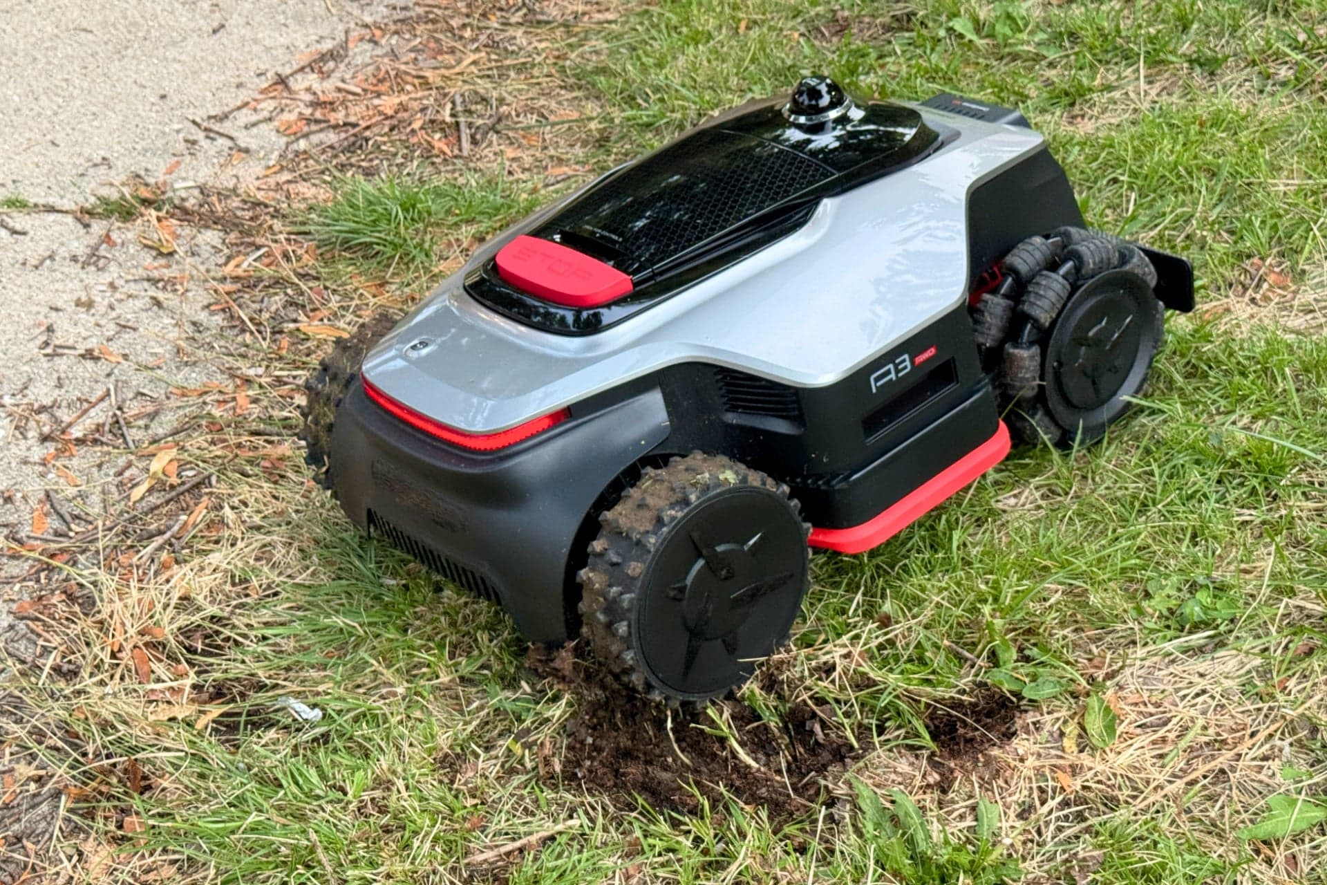 Dreame A3 AWD Pro 3500 after digging a rut into wet grass and exposing the soil beneath — © Wes Davis / Gizmodo