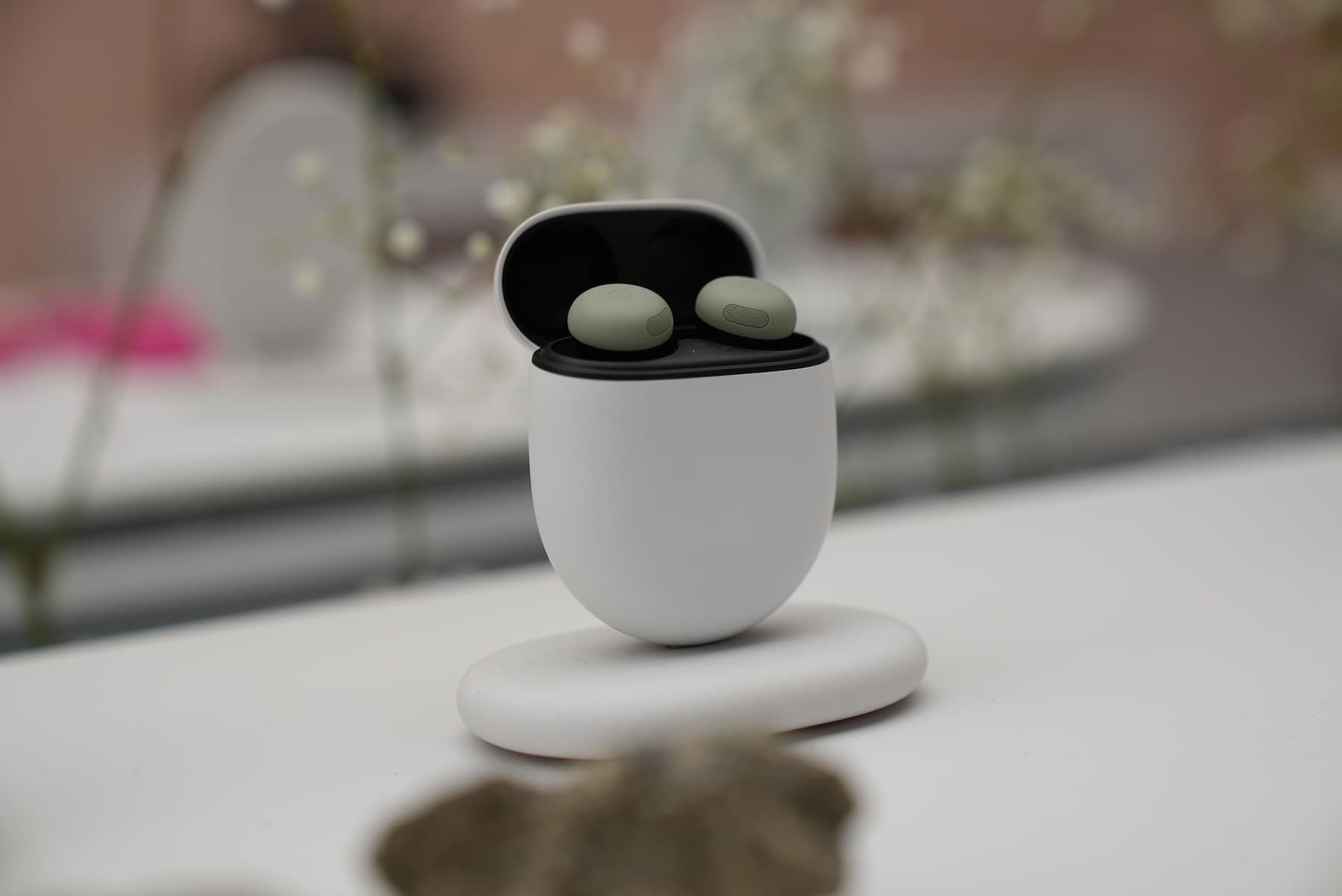 Olive Google Pixel Buds Pro 2 in their open case at the Made by Google 2026 event