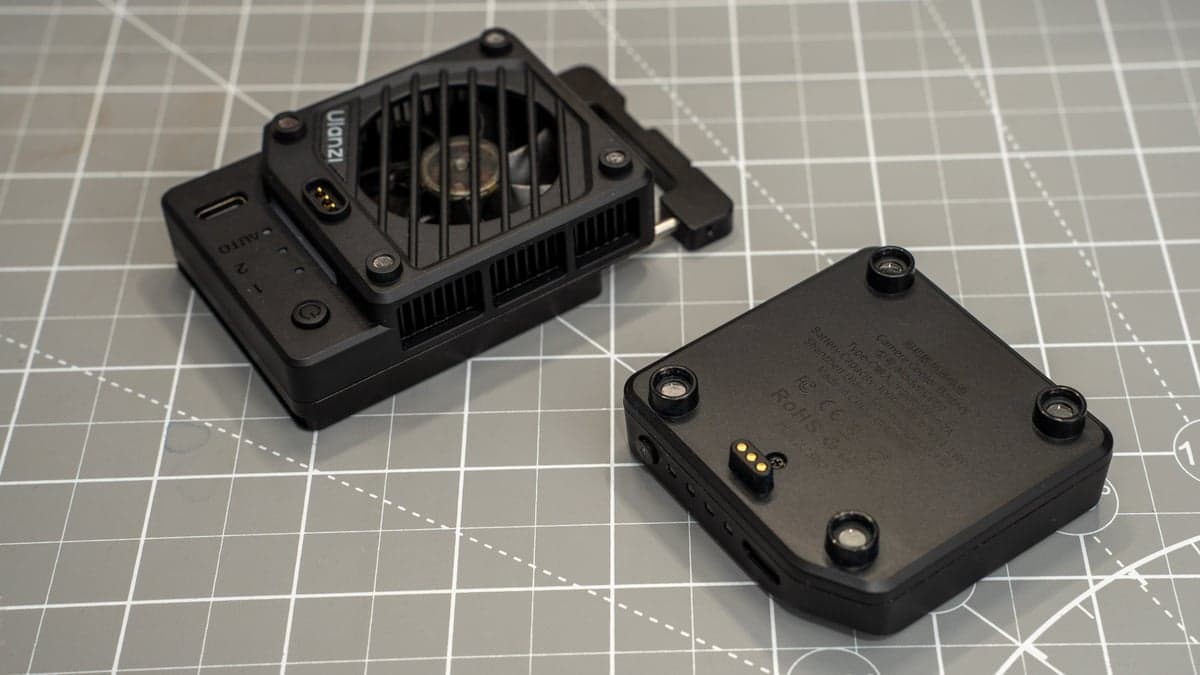 Gold-plated spring-loaded pogo pin interface on the cooler body and corresponding magnetic alignment recess on the battery pack